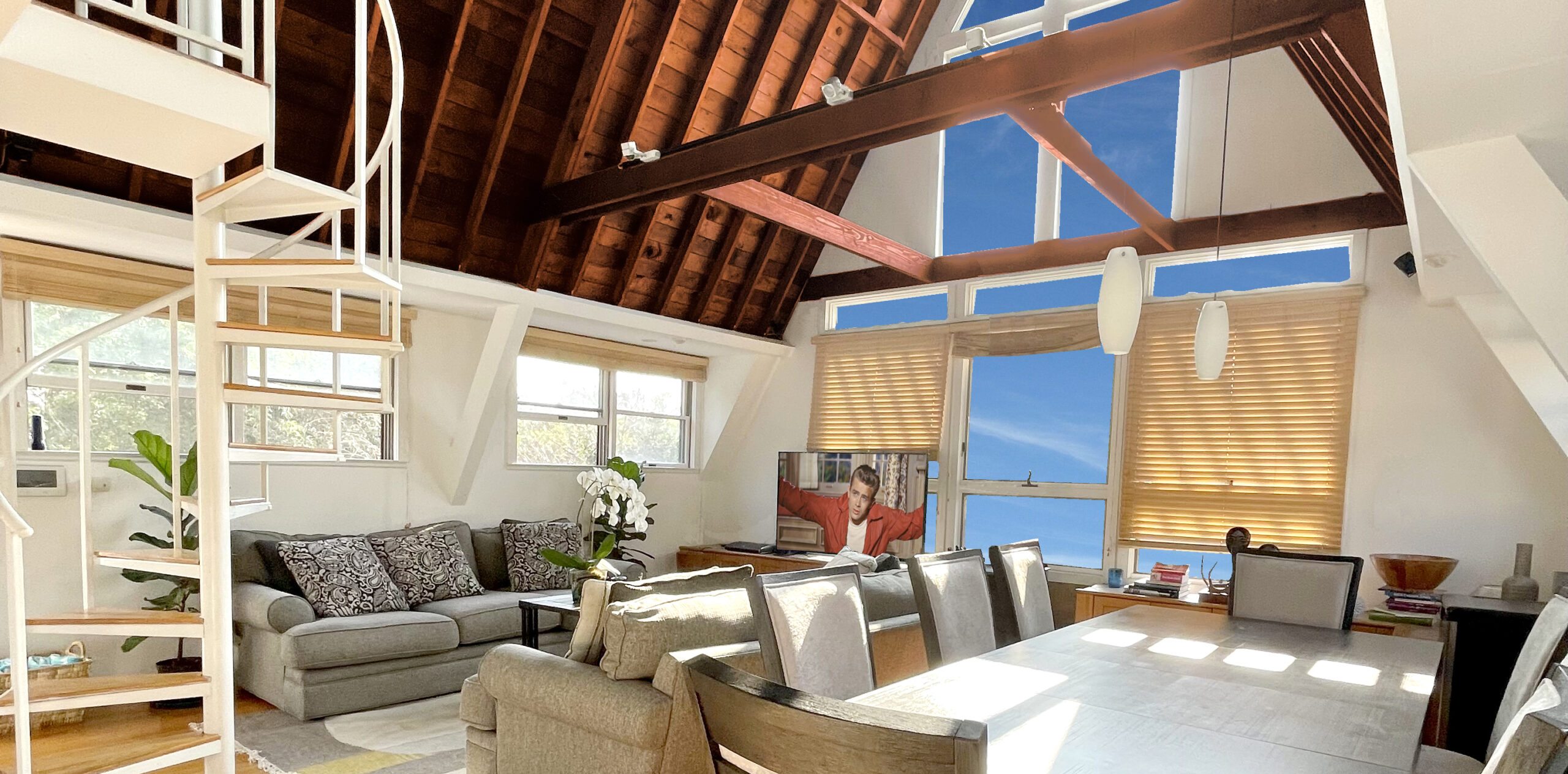 Fire Island Pines home rental living room and dining room view with solid wood a-frame vaulted ceilings, modern, comfortable seating and great views!