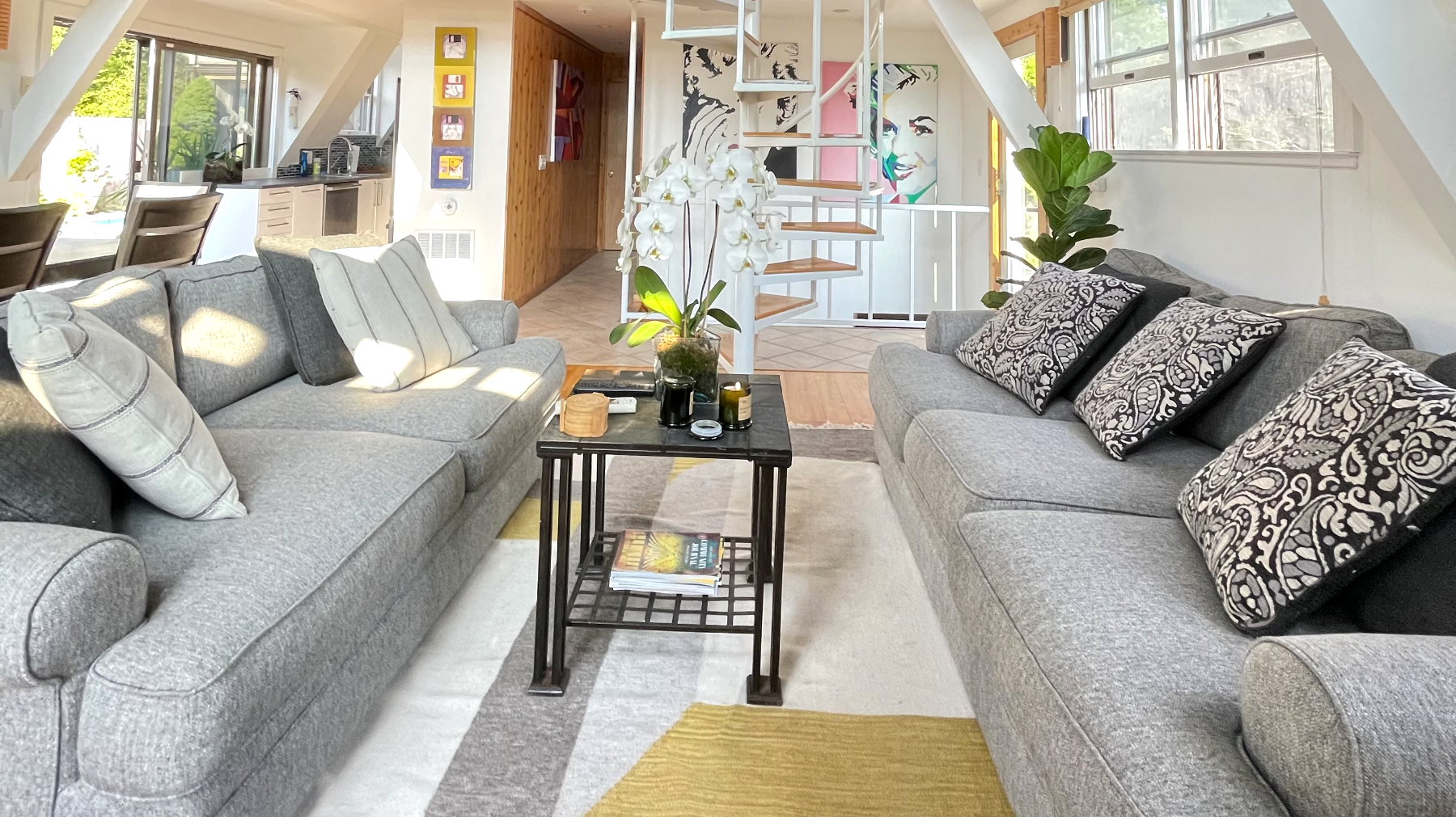Massive living and dinning room area with HVAC (cooling and heating), lush large area rugs, brand new sofas, sweeping views and tasteful art.